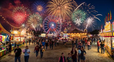 County fair rides and festival crowds at dusk